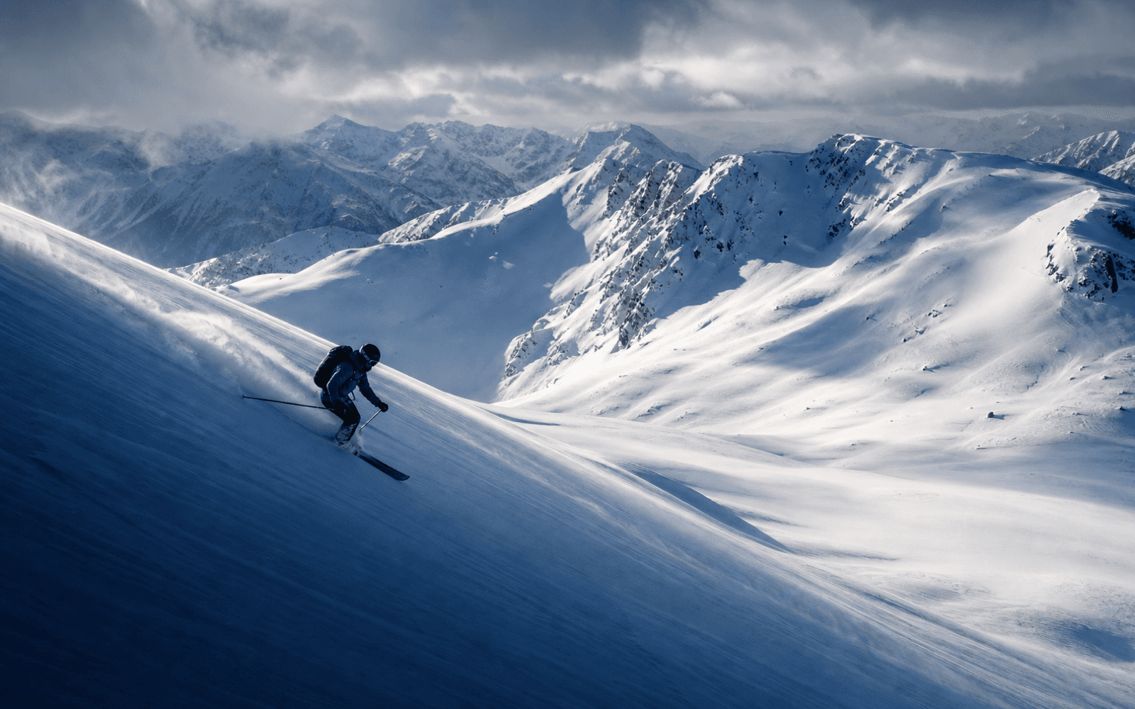 An advanced skier traversing an open alpine bowl in Whistler.