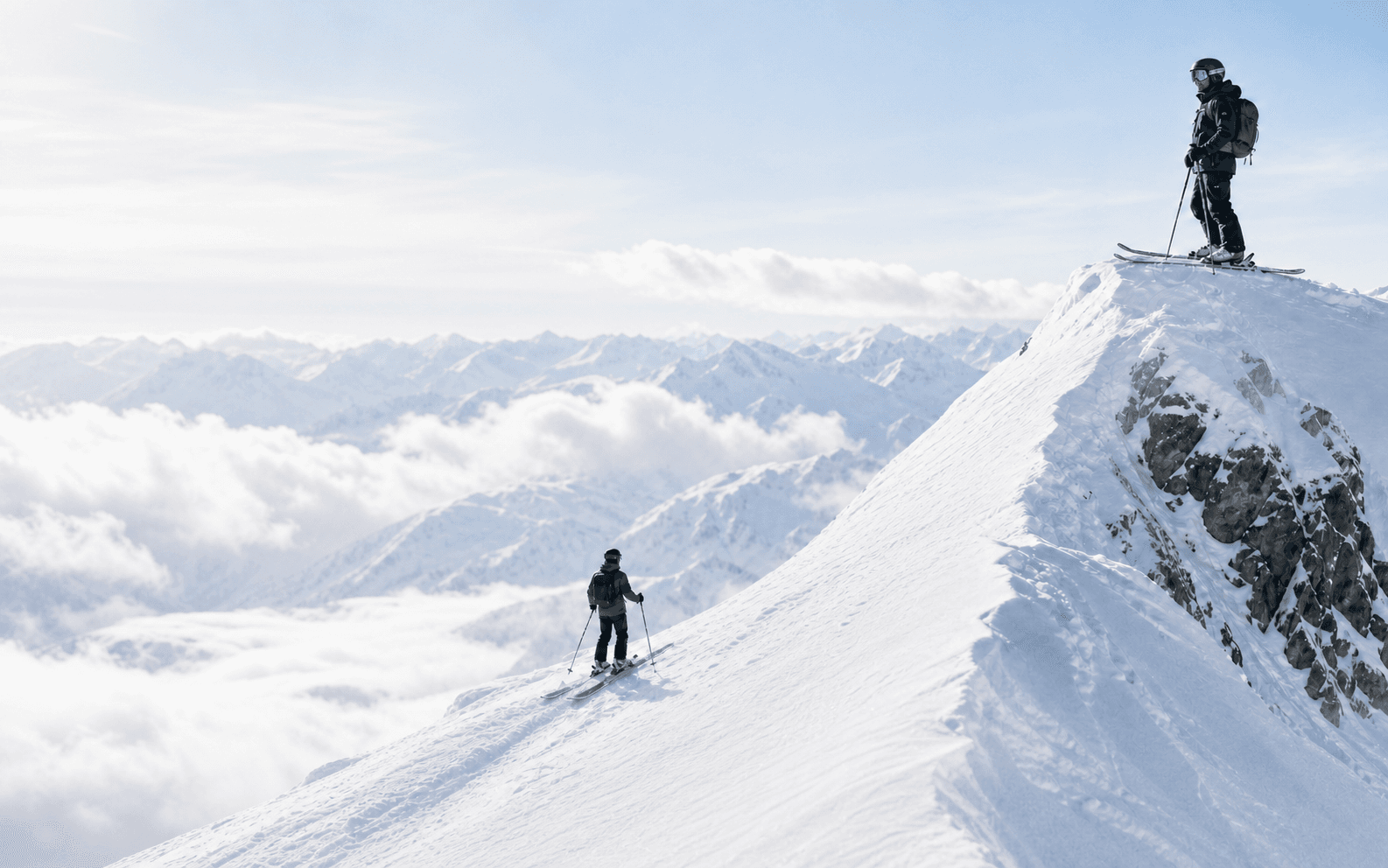 An early skier ascending toward a confident summit identity.